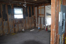 The flooding destroyed the drywall in the home of Mr. Brandis. The water height can be seen where the dry wall of cut from the floor up on the righthand side of this image. 