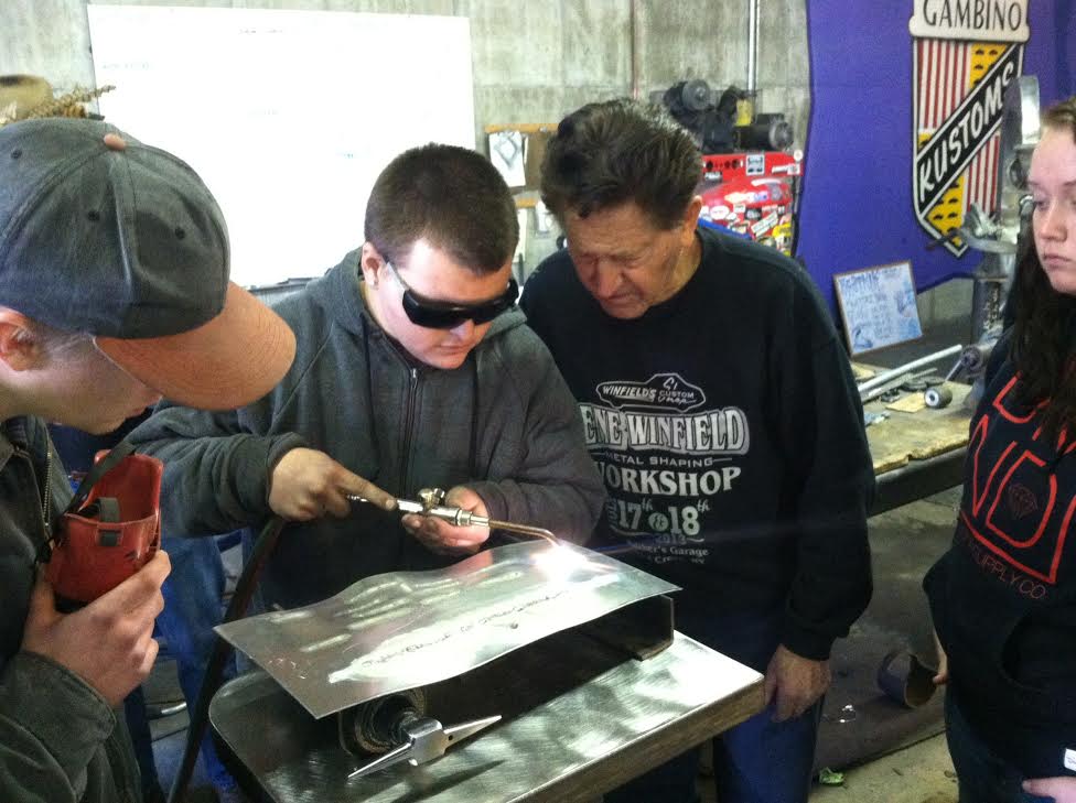 Mike Lindsay welding sheet metal as instructor Gene Winfield looks on.