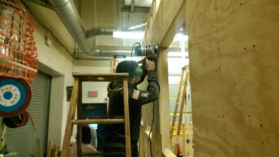 Materials Processing students cut window openings on the Tiny House with a router.